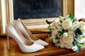 White roses bridal bouquet on the background of shoes Royalty Free Stock Photo