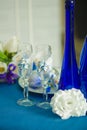 Bridal bouquet of blue iris white tulips glasses and bottles Royalty Free Stock Photo