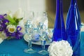 Bridal bouquet of blue iris white tulips glasses and bottles