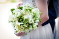 A bridal bouquet in the bride`s hands. Royalty Free Stock Photo