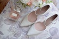 Bridal bouquet, bride shoes and earings on chair, copy space. Luxury wedding accessories and jewelry. Royalty Free Stock Photo