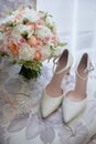 Bridal bouquet, bride shoes and earings on chair, copy space. Luxury wedding accessories and jewelry. Royalty Free Stock Photo