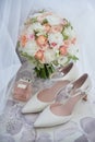 Bridal bouquet, bride shoes and earings on chair, copy space. Luxury wedding accessories and jewelry. Wedding concept. Royalty Free Stock Photo