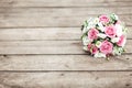 A bridal bouquet of a bride from white and pink roses lies on a wooden background, horizontally Royalty Free Stock Photo