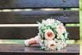 A bridal bouquet of a bride from white and pink roses lies on a wooden background, horizontally Royalty Free Stock Photo
