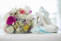 Bridal bouquet of colored roses, shoes and garter Royalty Free Stock Photo