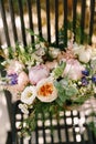 Bridal bouquet of cream roses, pink peonies, eustoma, waxflower, astilbe, limonium, branches of eucalypt tree, mattiola