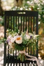 Bridal bouquet of cream roses, pink peonies, eustoma, waxflower, astilbe, limonium, branches of eucalypt tree, mattiola