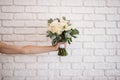 Bridal bouquet keeps hand on a white background