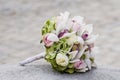 Bridal bouquet laying on stone block. Beautiful romantic white and pink wedding flowers with copy space and blurred background. Royalty Free Stock Photo