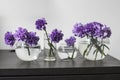 Bridal bouquet of lilac carnations in a round glass vase