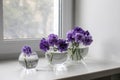 Bridal bouquet of lilac carnations in a round glass vase