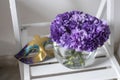 Bridal bouquet of lilac carnations in a round glass vase