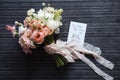 Bridal bouquet lying near wedding rings and postcard Royalty Free Stock Photo