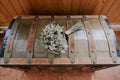 Bridal bouquet on an old trunk