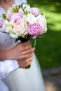 Bridal bouquet of peonies and roses. Hold wedding flowers in your hands Royalty Free Stock Photo