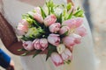 Bridal bouquet with pink tulips in the hands of the bride. Royalty Free Stock Photo