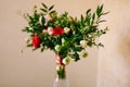 Bridal bouquet of red and pink roses, boxwood branches, not blooming buds of white flowers and red ribbons with brooch Royalty Free Stock Photo