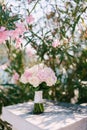 Bridal bouquet of rose and cream roses and calla lilies white stone railway near the blooming rose oleander bush