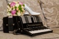 Bridal bouquet, shoes and rings on accordion.