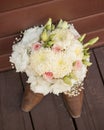 Bridal bouquet sitting on top of cowgirl boots