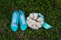Bridal bouquet and turquoise shoes on green grass