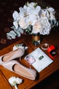 Bridal bouquet, two buttonholes, women`s shoes, wedding rings in a box, women`s bracelet, envelope with a wed Royalty Free Stock Photo