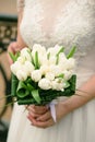 Bridal bouquet on the wedding day. Beautiful girl holding a bouquet of white tulips. Royalty Free Stock Photo