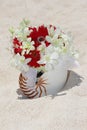 Bridal bouquet with wedding rings in a shell on sand tropical be Royalty Free Stock Photo