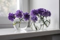 Bridal bouquet of lilac carnations in a round glass vase