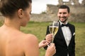 Bridal couple clink glasses of champagne