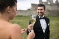 Bridal couple clink glasses of champagne