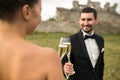 Bridal couple clink glasses of champagne