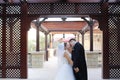 Bridal couple holding hands and kissing Royalty Free Stock Photo