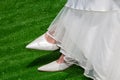 Bridal Elegance: Classic White Wedding Shoes on Lush Green Royalty Free Stock Photo