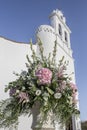 Bridal flowers bouquet close to whitewashed church Royalty Free Stock Photo