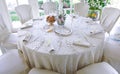 Bridal mise en place with white lace tablecloth and silver cutlery