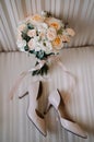 Bridal morning details composition. Top view of wedding rings, beautiful bouquet of pink flowers with ribbons, boutonniere and Royalty Free Stock Photo