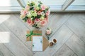 Bridal morning details composition. Top view of wedding rings, beautiful bouquet of pink flowers with ribbons. Flat lay Royalty Free Stock Photo