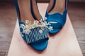 Bridal morning details composition: wedding rings and blue leather shoes. Royalty Free Stock Photo