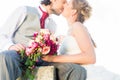 Bridal pair kissing on field