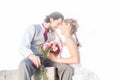 Bridal pair kissing on field after wedding Royalty Free Stock Photo