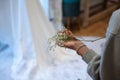 Bridal preparations. A bridesmaid holds a bunch of flowers