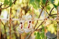 Bridal sandals with large stones on a metal old fence. Royalty Free Stock Photo