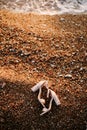 Bridal sandals with thick heels decorated with stones on a pebble beach on the sea. Royalty Free Stock Photo