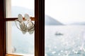 Bridal sandals on a wooden window frame overlooking the sea. Royalty Free Stock Photo