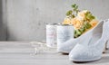 Bridal shoes next to cans and flower bouquet Royalty Free Stock Photo