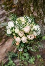 Bridal vintage bouquet. The bride`s . Beautiful of mixed flowers and greenery, decorated with silk ribbon, lies on vintage wooden Royalty Free Stock Photo