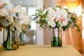 A bridal wedding bouquet in a glass jar before the wedding ceremony, White and pink flowers set down on a table Royalty Free Stock Photo