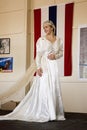 Bride in 1940s wedding dress posing in front of flag Royalty Free Stock Photo
